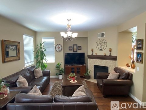 A living room with a fireplace and a television.