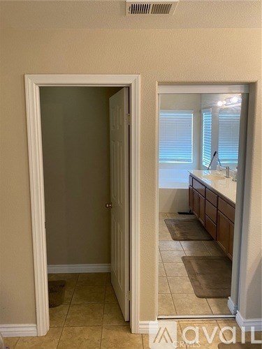 A white door is open to a bathroom.