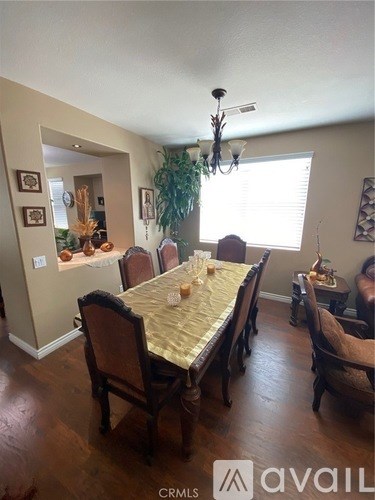 A dining room with a table set for six people.