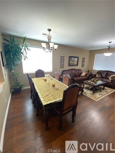 A dining room with a wooden table and chairs.