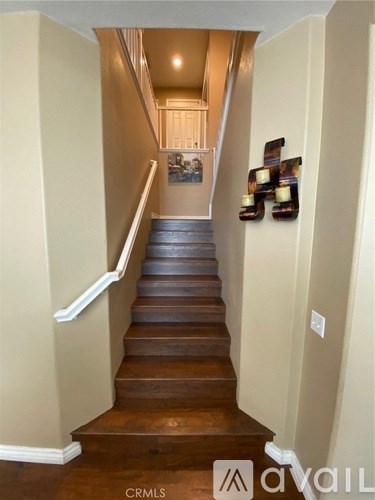 A staircase with a white railing and wooden steps.