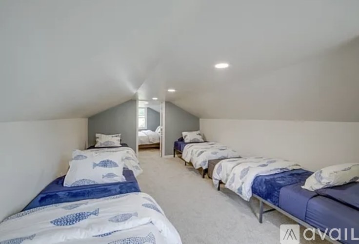 A room with multiple beds and a sign that says "available".