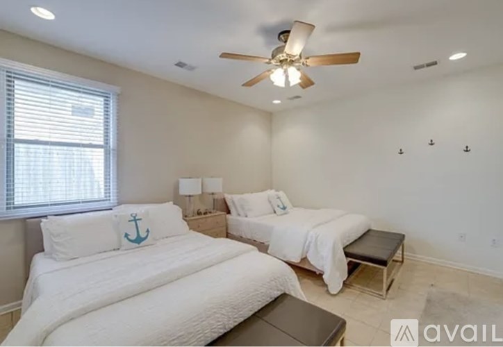 A bedroom with a bed and a massage table.