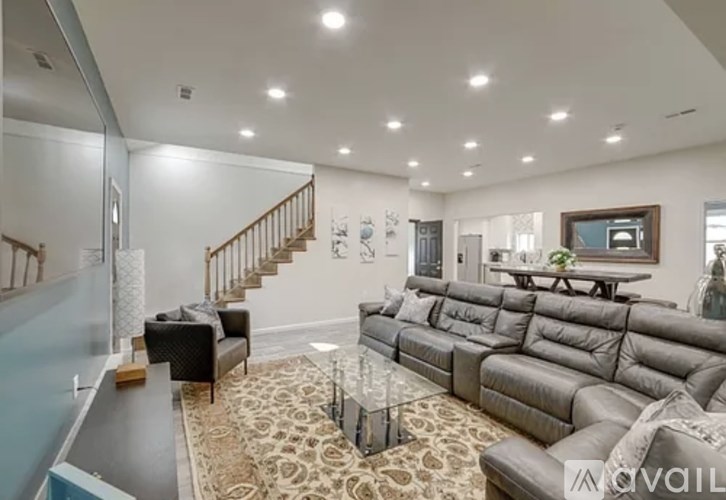 A living room with a staircase and a couch.