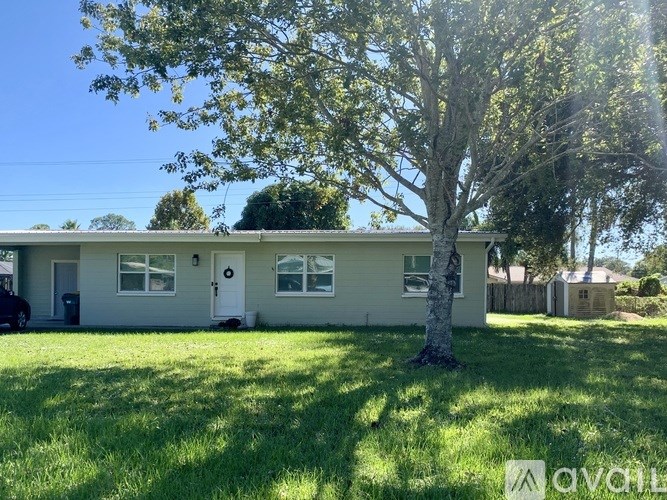 A house with a tree in front of it.