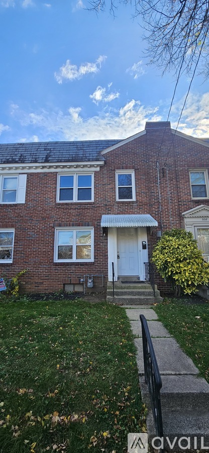 A house with a white door and windows is shown.
