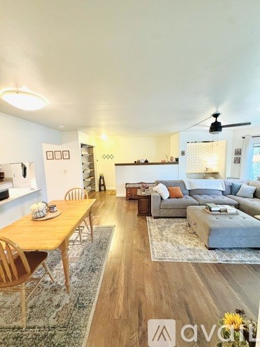 A living room with a wooden table and chairs.