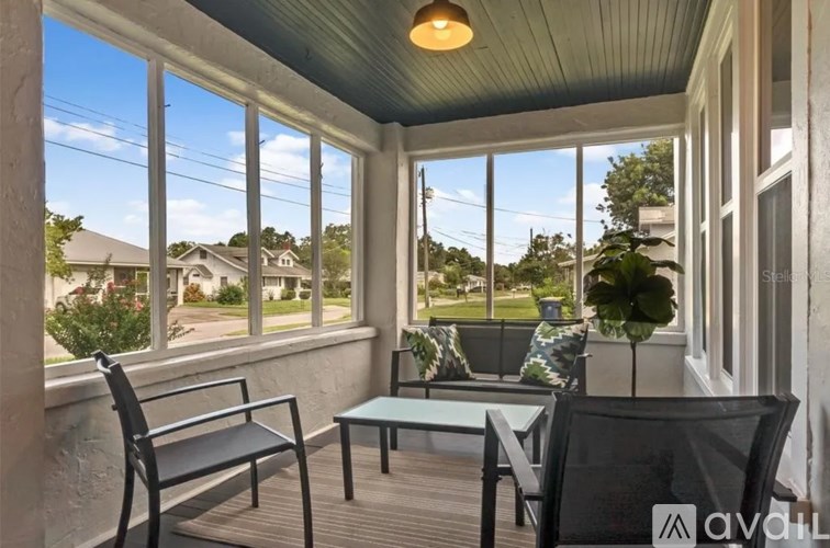 A sunny day at the patio with a table and chairs.