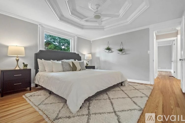 A bedroom with a large bed and a window.