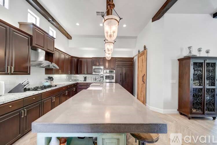 A kitchen with a large island in the middle.