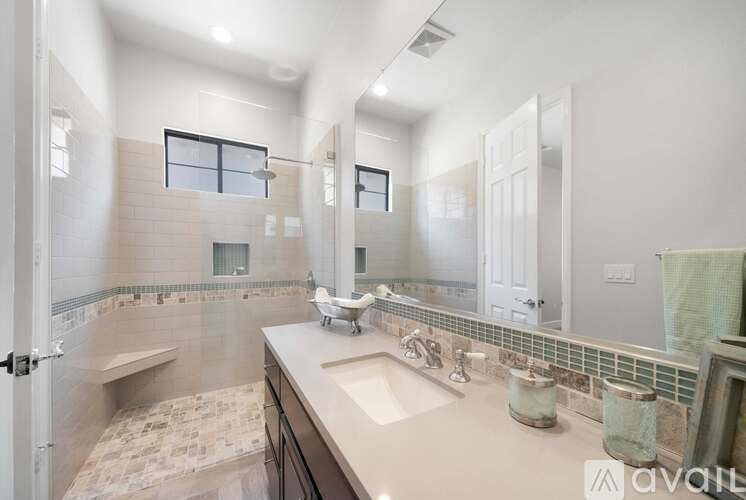 A bathroom with a walk-in shower and a sink.