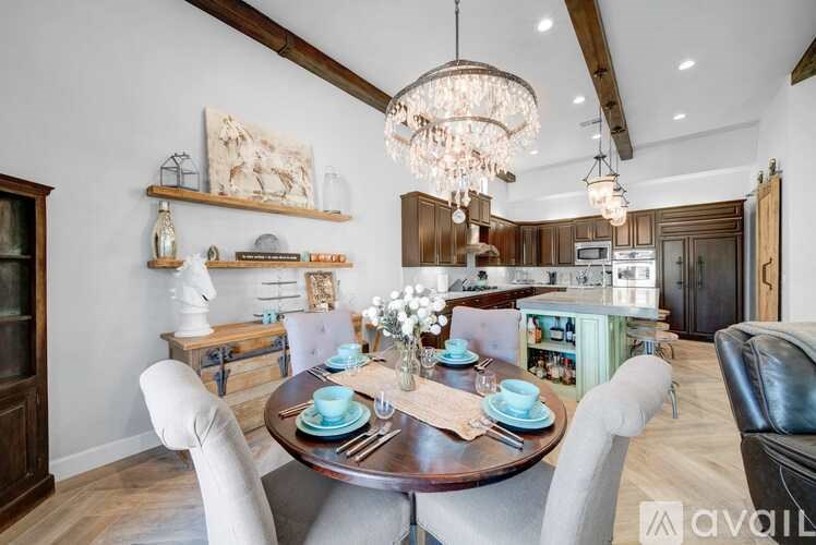 A dining room with a wooden table set for four.