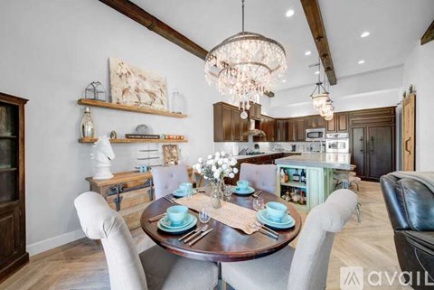 A dining room with a wooden table set for four.