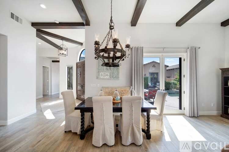 A dining room with a wooden table and chairs.