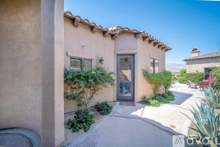 A house with a beige stucco exterior and a tiled roof.