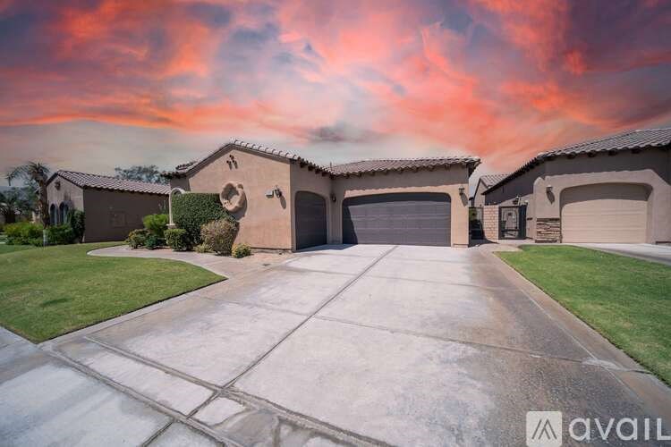 A house with a driveway and garage is available for sale.