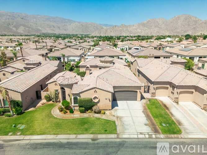 A bird's eye view of a neighborhood with houses and green lawns.