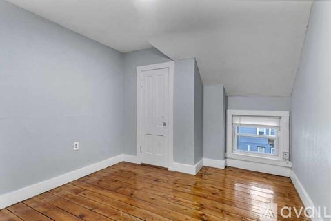A room with wooden floors and a white door.