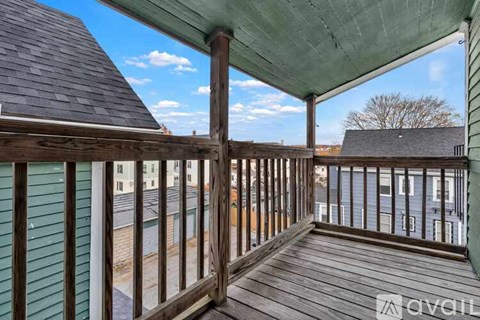 A balcony with a view of other buildings and a clear sky.