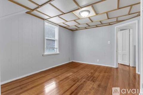 A room with wooden floors and a window.