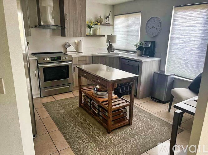 A kitchen with a table and a stove.