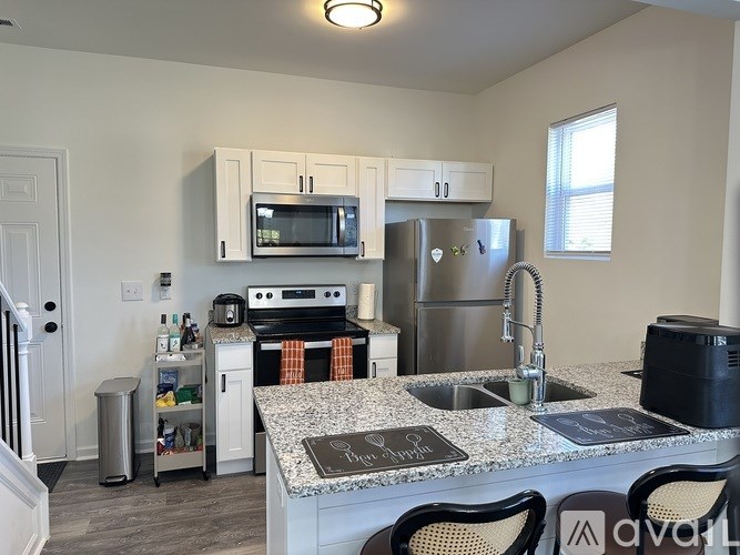 A kitchen with granite countertops and stainless steel appliances.