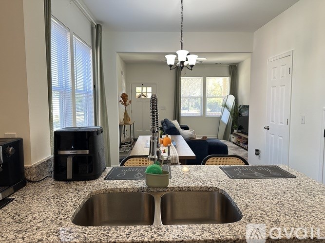 A kitchen with granite countertops and a stainless steel sink.