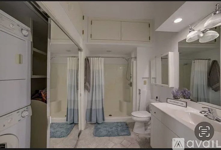 A bathroom with a washer and dryer built in.