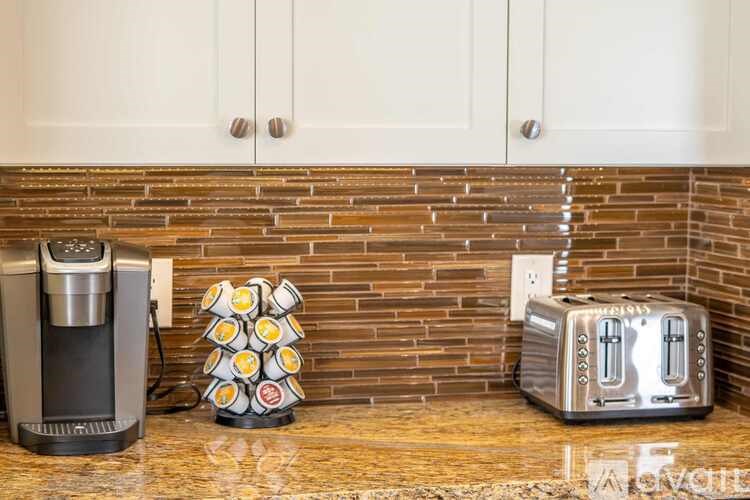 A toaster and a coffee maker on a countertop.