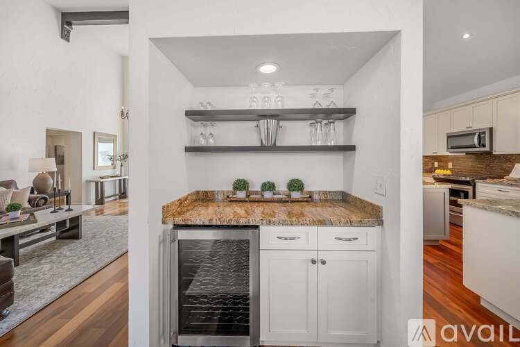 A kitchen with a granite countertop and white cabinets.