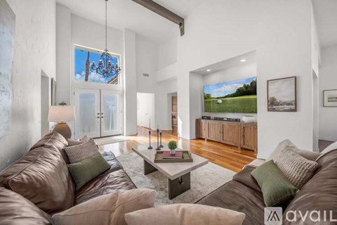 A living room with brown leather sofas and a coffee table.