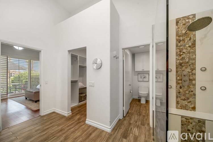 A bathroom with a stone wall and a toilet.