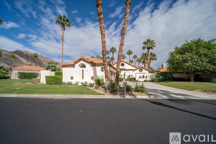 A house with a palm tree in front of it.