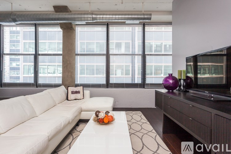A living room with a white couch and a television.
