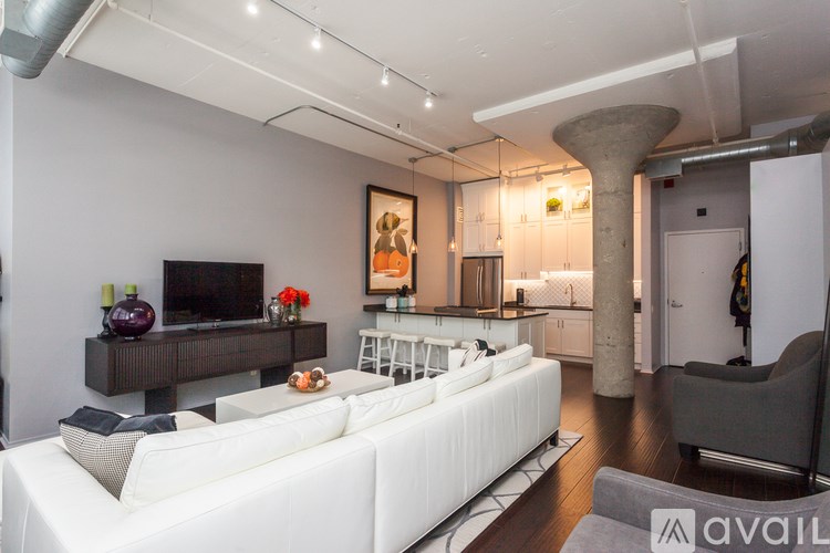 A modern living room with a white couch and a television.