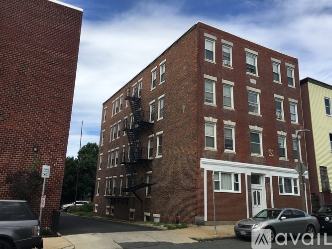 A red brick building with a fire escape on the side.