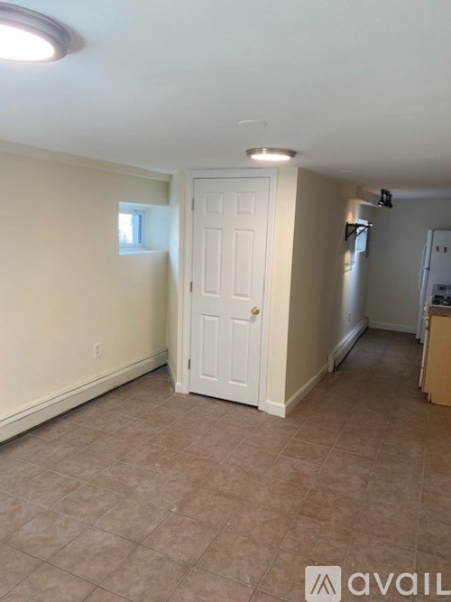 A room with a white door and a window.