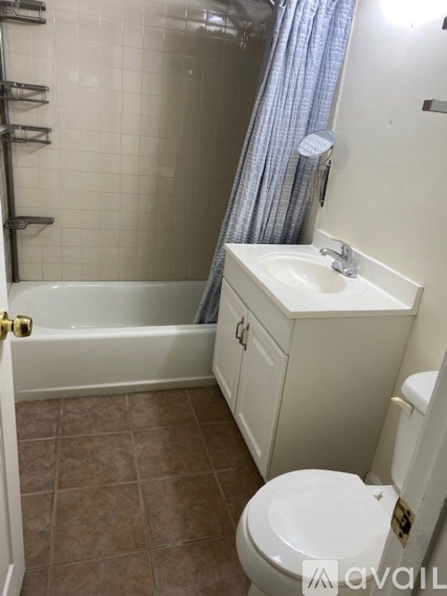 A bathroom with a toilet, sink, and bathtub.