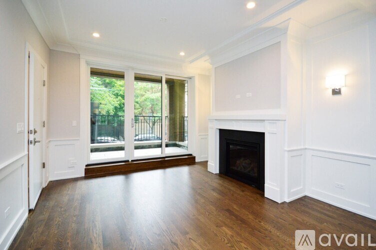 A spacious living room with a fireplace and sliding glass doors.