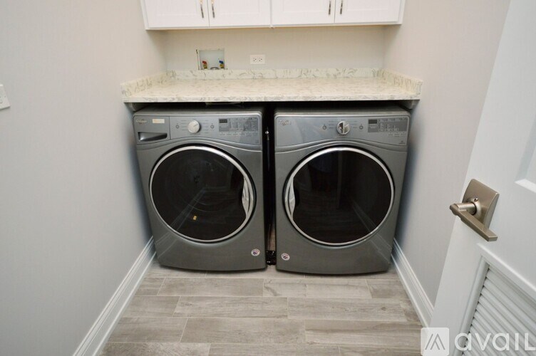 Two front load washing machines in a laundry room.
