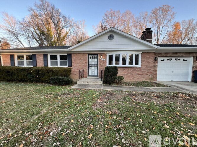 A house with a front yard and a garage door.