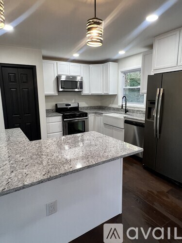A kitchen with granite countertops and stainless steel appliances.