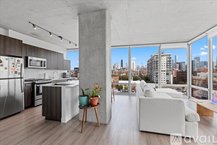 A modern kitchen with a view of the city skyline.