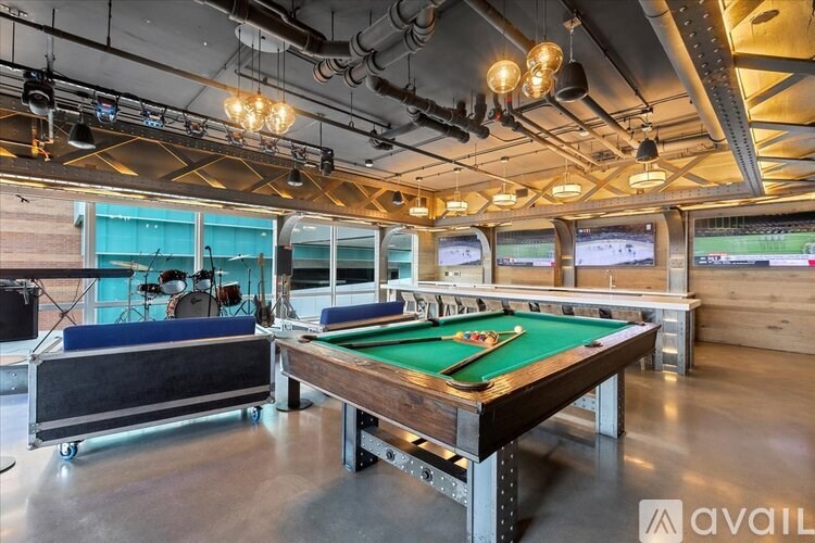 A pool table with a green felt cloth is in the center of the room.