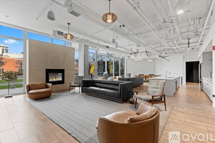 A modern living room with a fireplace and a large couch.