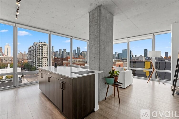 A modern kitchen with a view of the city skyline.