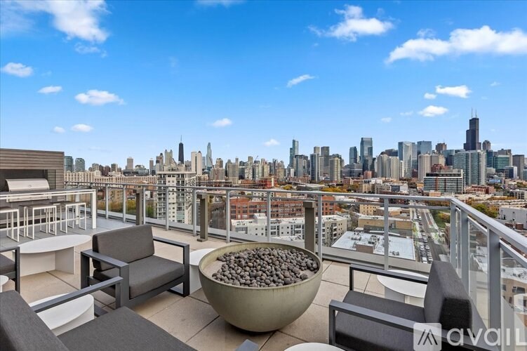 A balcony with a bowl of rocks in the foreground and a city skyline in the background.