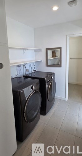 Two front load washing machines in a laundry room.