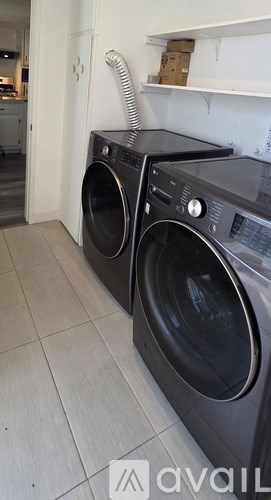 Two front loading washing machines in a laundry room.
