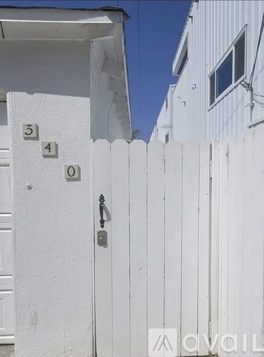 A white fence with the numbers 3, 4, and 0 on it.